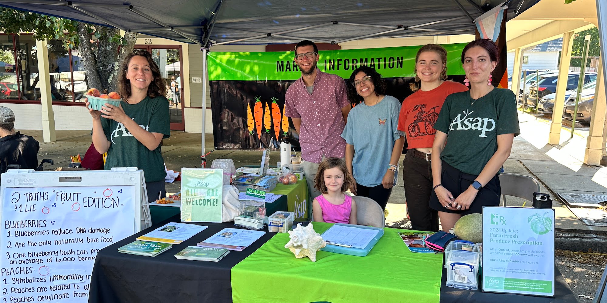 William Yates, center, with a market engagement activity at Asheville City Market